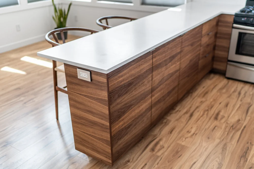 Walnut kitchen island with marble countertop by Paulson Construction